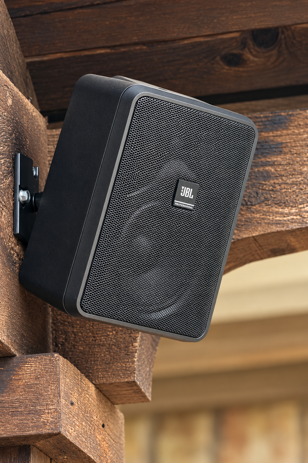 Close-up of a JBL outdoor speaker installed beneath a timber patio beam in Trophy Club